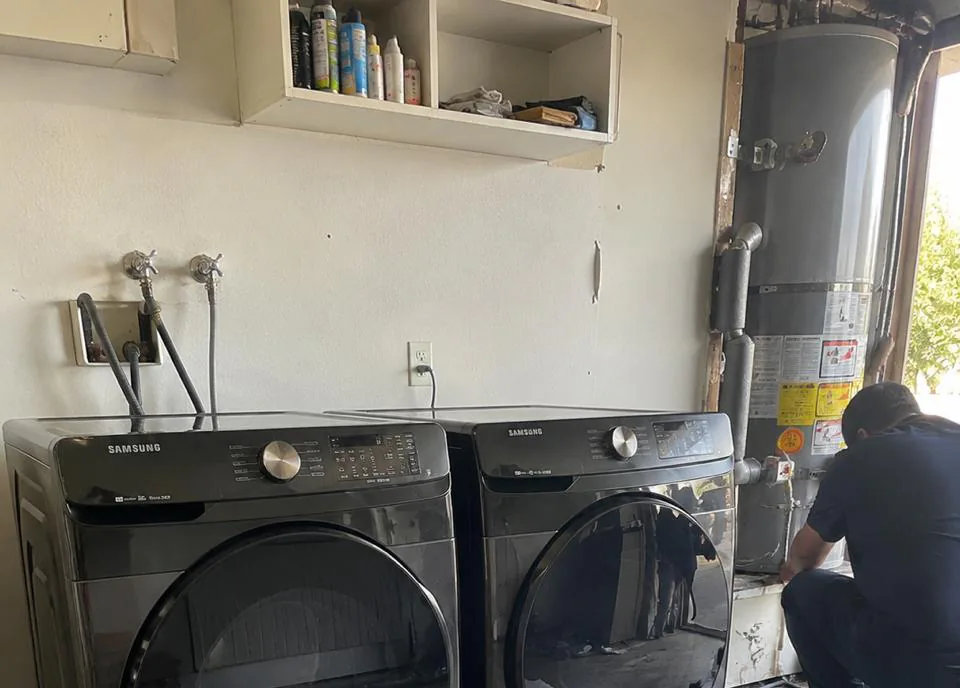 Appliance technician repairing a refrigerator in an Anaheim, CA kitchen near Disneyland